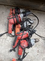 Pile of five Milwaukee corded tools showing overall lot
