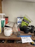 All items on shelf: cable ties, lubricant, twine, gear puller box, NeverWet, gate latch, black containers, clamp