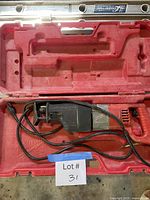 Saw inside open red carry case