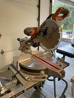 Full view of Ridgid 12" sliding compound miter saw on utility stand