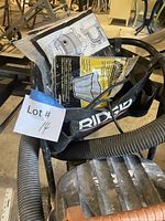 Vacuum top, RIDGID logo bag with manuals and hose visible