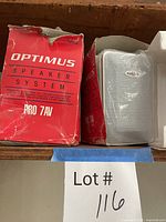 Both Optimus PRO 7AV speaker boxes with one speaker visible in packing