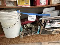 Shelf with pail of loose nails and boxes of collated nails