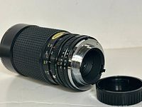 Tokina Zoom Lens 35-208mm f/3.5-4.5 with lens mount and rear cap visible.