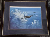 Framed aviation print showing two Wellington bombers flying in a partly cloudy blue sky, prominently displayed within double mat and frame.