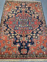 Full view of the Persian handmade wool rug showing main design and colors.