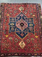 Full view of the Persian wool rug showing the full geometric floral pattern and border.