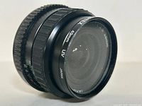 Takumar 28mm f/2.8 camera lens with front glass element visible, showing 'Takumar 28mm UV Japan' markings