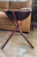 Side view of Baribocraft wooden salad bowl on matching wooden tripod floor stand against tiled floor background.