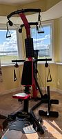 Full front view of the BowFlex PR3000 showing seat, rods, pulleys and base