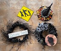 Full view of all decorations showing witch hat, two wreaths, and zombie crossing sign