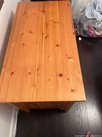 Top view of wooden dresser showing surface and wood grain texture.