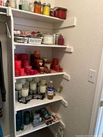 Full shelving unit with variety of candles and accessories
