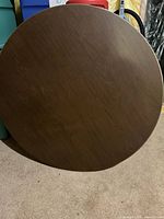 round wood-grain laminate card table top