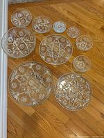 Group shot of all 11 pressed glass pieces on floor
