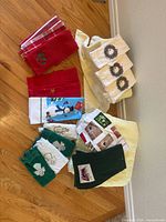 Group shot showing all fifteen assorted holiday hand towels laid out on floor