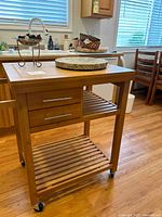 Full view of bamboo kitchen cart with granite tray on top