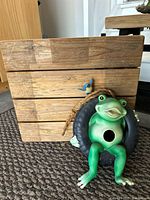 wood-slat crate and frog-in-tire ornament