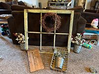 All items grouped: window frame, wreath, two galvanized wall buckets with faux florals, wooden plaque, woven basket with tin planter