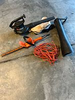 Overview of Toro blower/vac, Black & Decker hedge trimmer, extension cord, tube and bag