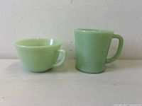 Mug and cup side by side showing height and form