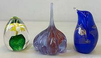 All three glass paperweights front view