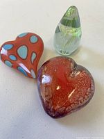 Group shot of three art glass paperweights