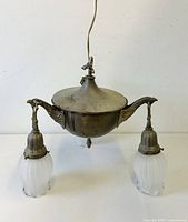 Full view of brass ceiling pan light showing hanging wire, two visible tulip shades and arm design