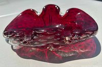 Top view of ruby Murano bowl highlighting controlled bubbles and shape