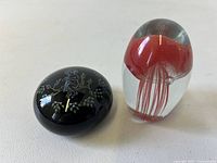 Both paperweights side by side