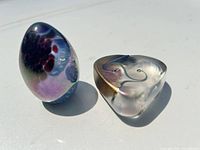 Front view of both paperweights showing shapes and coloration