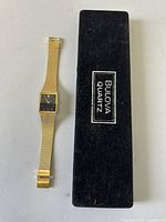 Watch beside closed Bulova Quartz box