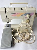 Front view of Bernina 1005 sewing machine with foot pedal and cord