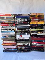 Front view of stacked books showing variety of titles and authors