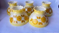 Group view of all five matching yellow floral glass shades