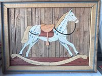 Full view of framed marquetry rocking horse panel
