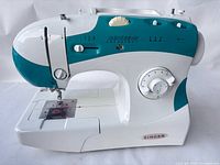 Left-front view of Singer 6038 sewing machine showing controls and stitch panel