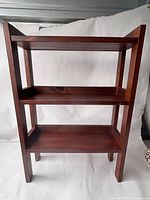 Full view of three-tier mahogany bookshelf showing overall design and finish