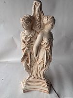 Full view of figural lamp showing two of the three classical women and column detail