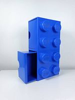 Two blue LEGO storage drawers shown with one pulled out.