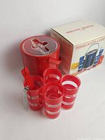 Photo showing the full set with ice bucket, cups, bar spoons, ice tongs, and original box.