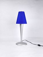 Full view of vintage Kvartett table lamp with blue cobalt glass shade on silver metal base showing entire lamp and power cord.