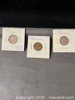 Front view of three Wheat cents in holders dated 1918, 1919, 1920