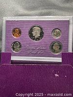 Front view of sealed five-coin 1986 proof set in purple holder