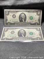 Front view of both 1976 two-dollar bills in sleeves
