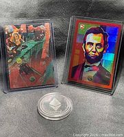 Fronts of Bitcoin and Abraham Lincoln cards with Ethereum coin
