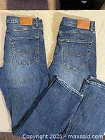 Back view of both pairs showing pockets and leather logo patches