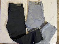 Full view of both pairs laid flat showing color and back pocket style