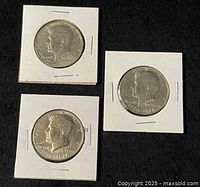 Three Bicentennial half dollars obverse in flips