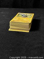 Stack of yellow-border Pokémon cards showing thickness of lot